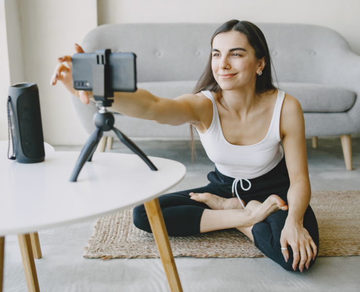 Woman filming self for fitness video