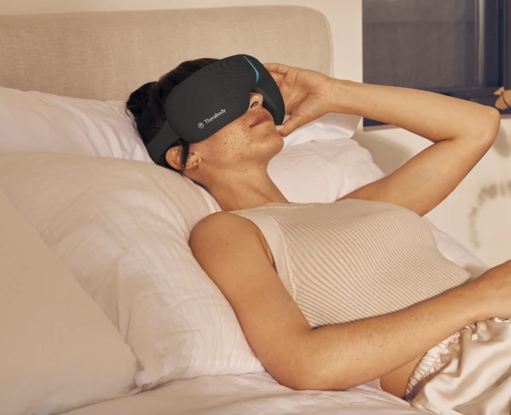 Woman in bed with eyecover on