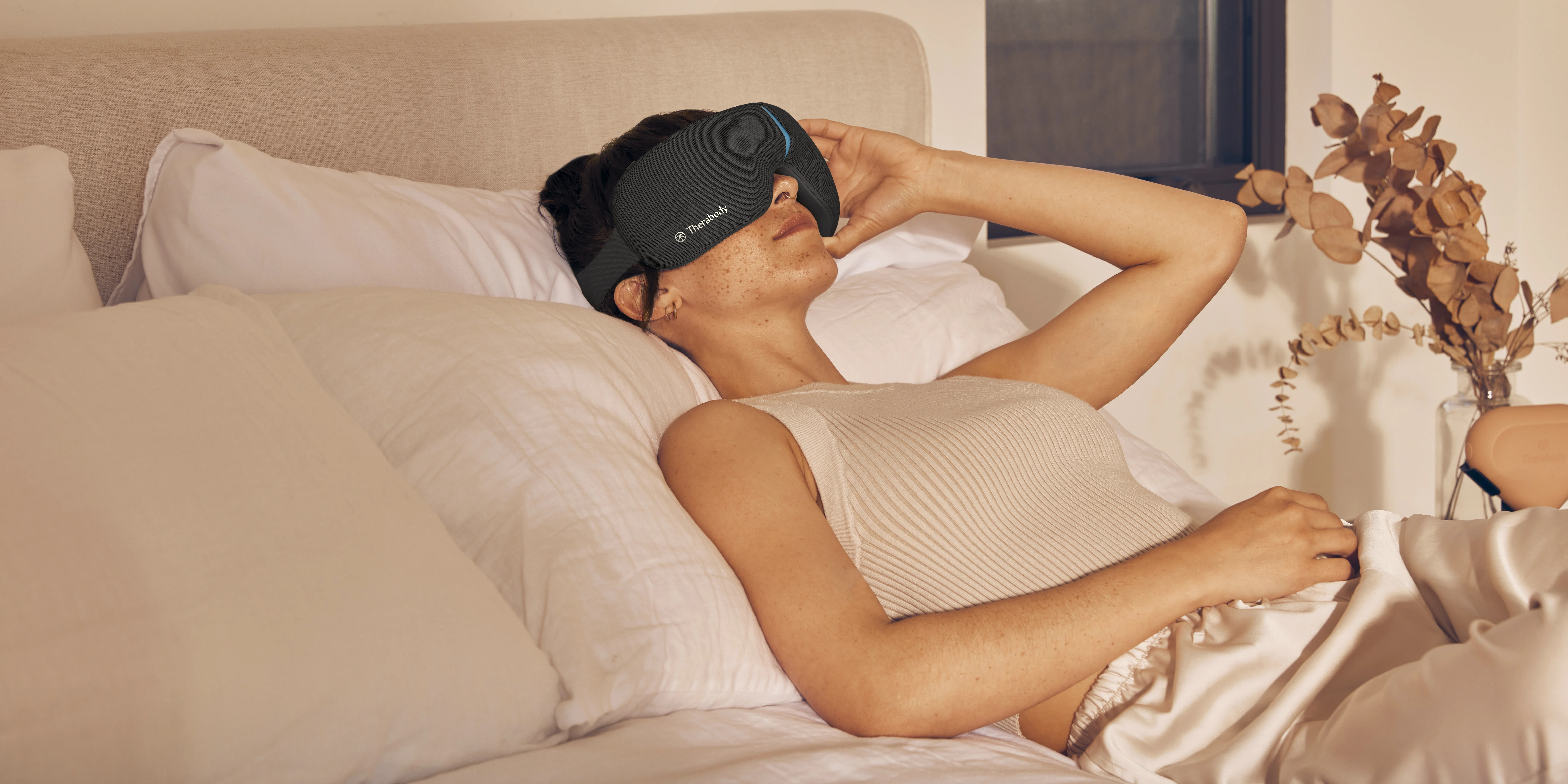 Woman in bed with eyecover on