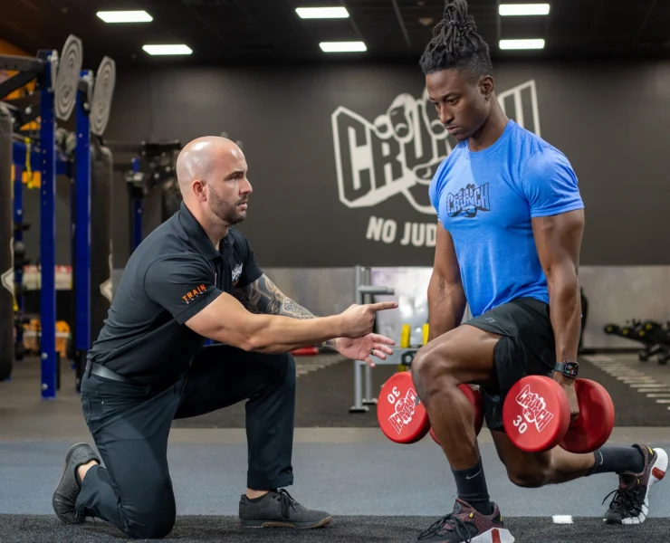 man works out at Crunch Fitness during a personal training session