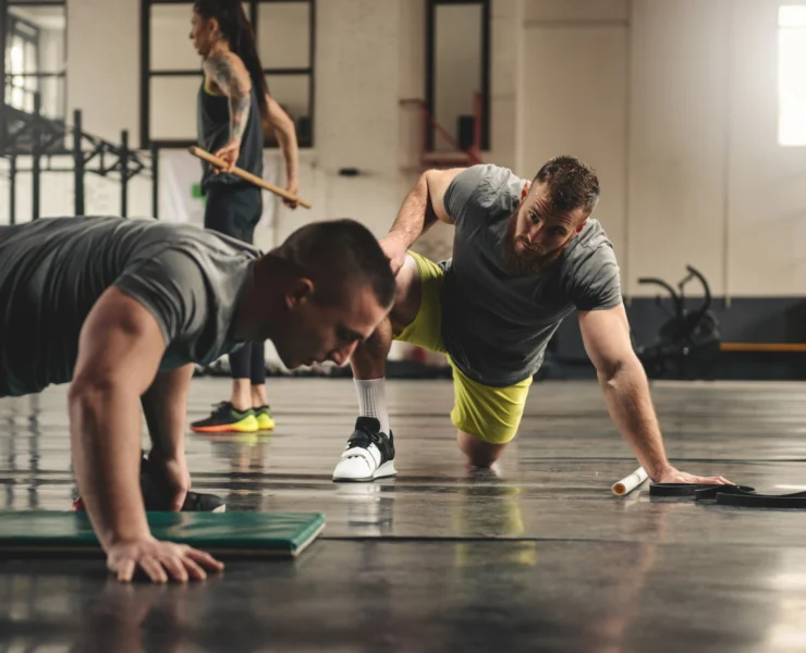 a fitness trainer working with a client