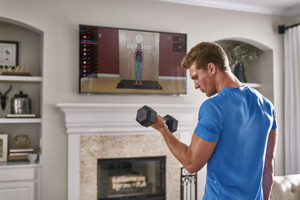 a man in a blue shirt working out with Echelon