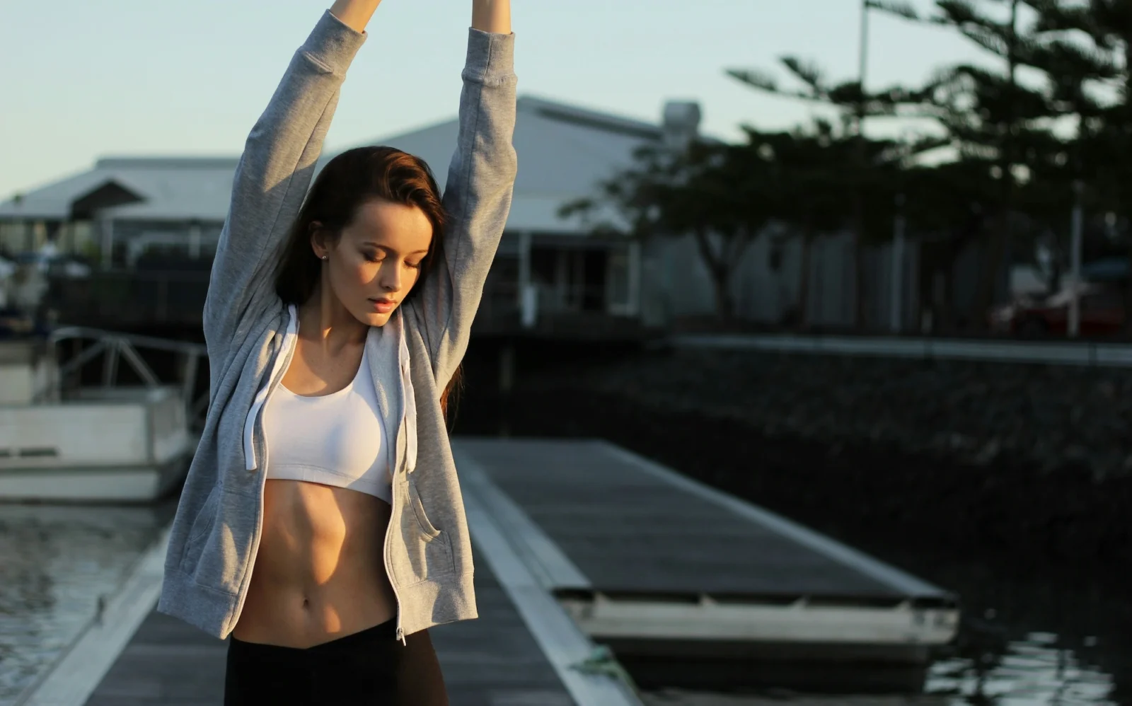 woman stretches her arms in workout gear