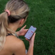 athletic woman looks at her smartphone