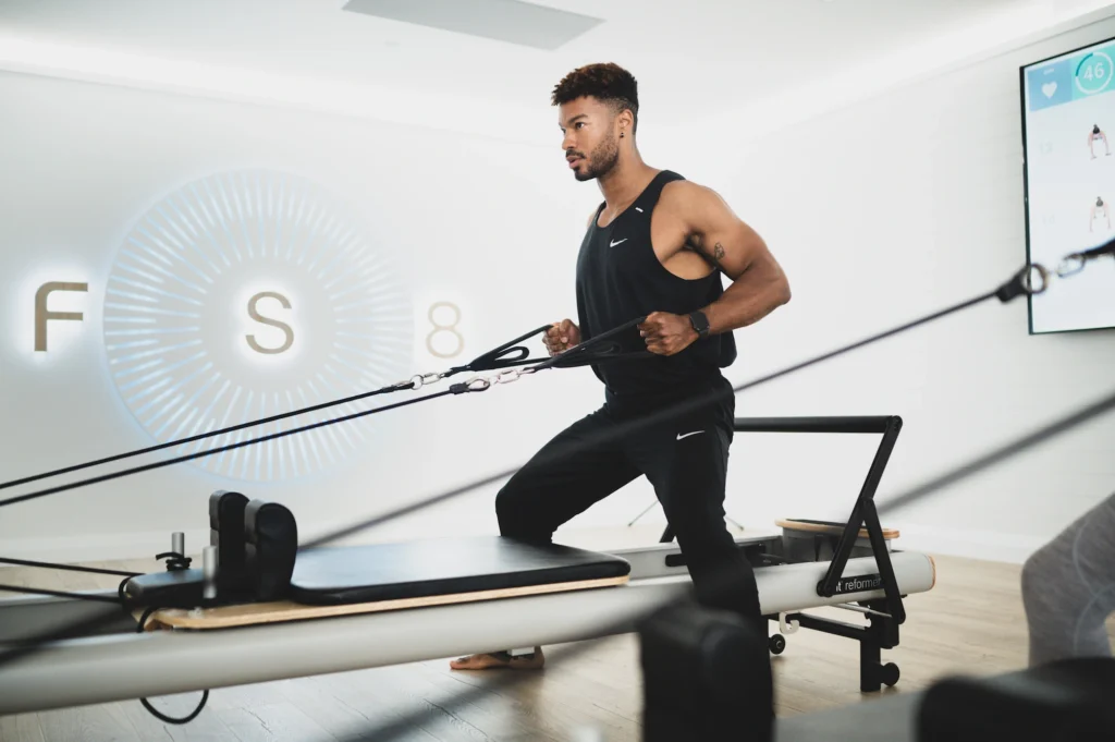 Man does Pilates exercise at FS8 studio