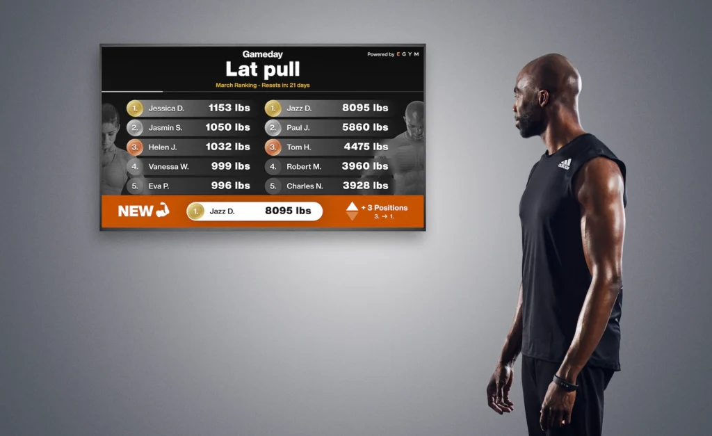 man looks at a digital fitness leaderboard