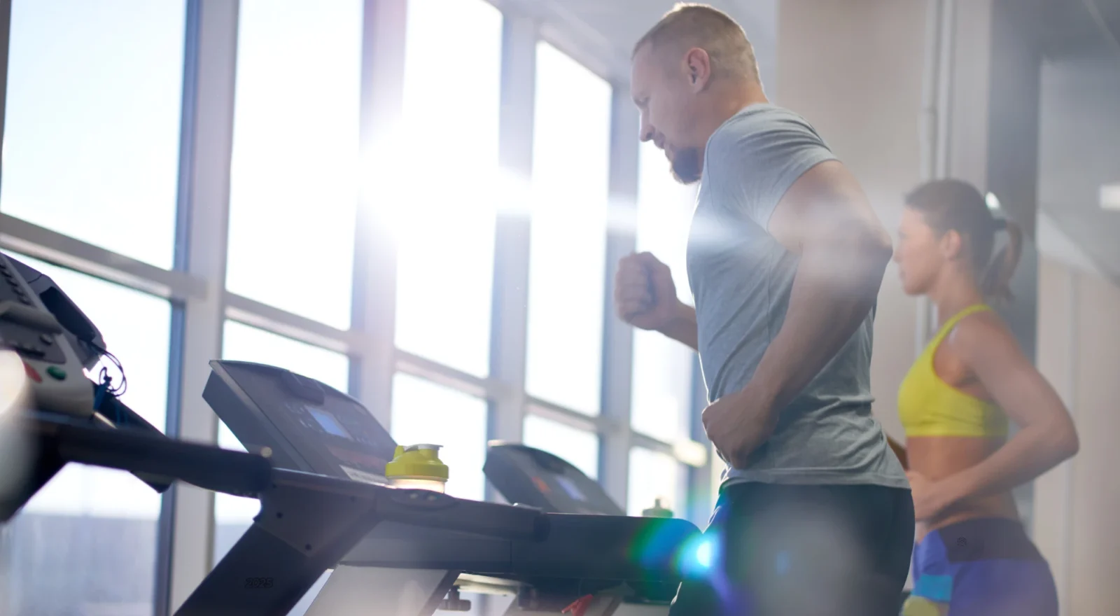 man and woman on treadmills