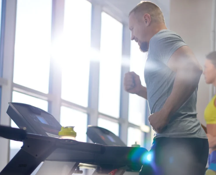 man and woman on treadmills