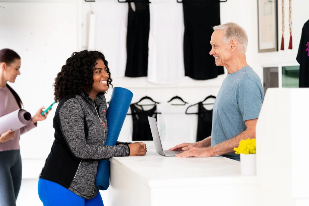 woman checks in at a gym desk