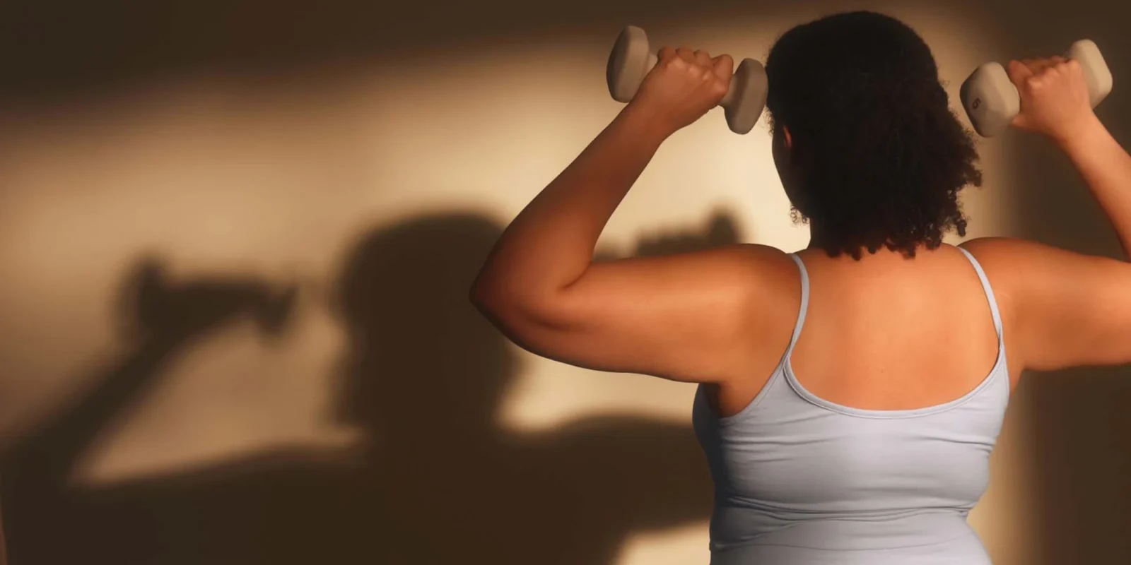 a woman strength training with hand weights