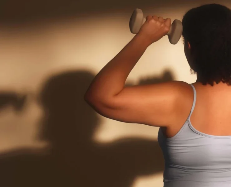 a woman strength training with hand weights