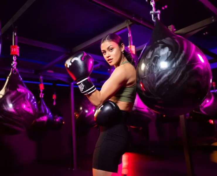 woman poses in a Rumble Boxing studio