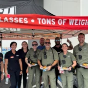 Crunch Fitness staff members and local community members gather in front of a Florida gym