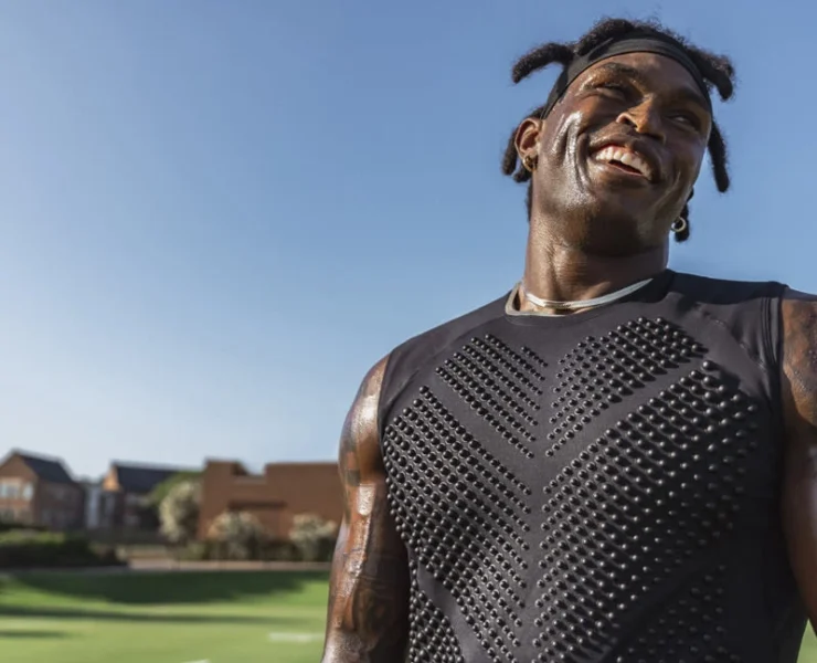 Black man wearing a weighted shirt to work out.