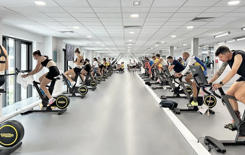 people work out on Technogym equipment in a center during the Paris Olympics