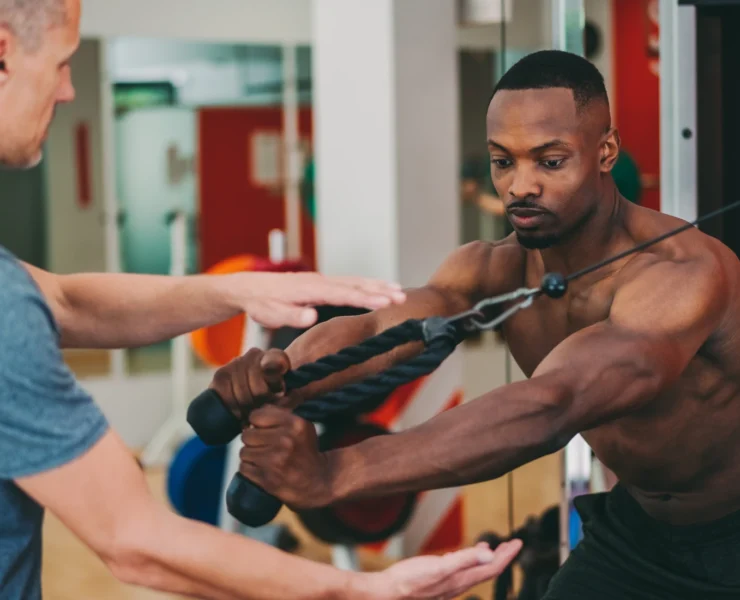 Personal trainer working out with client