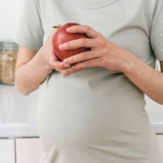 Pregnant woman holding an apple