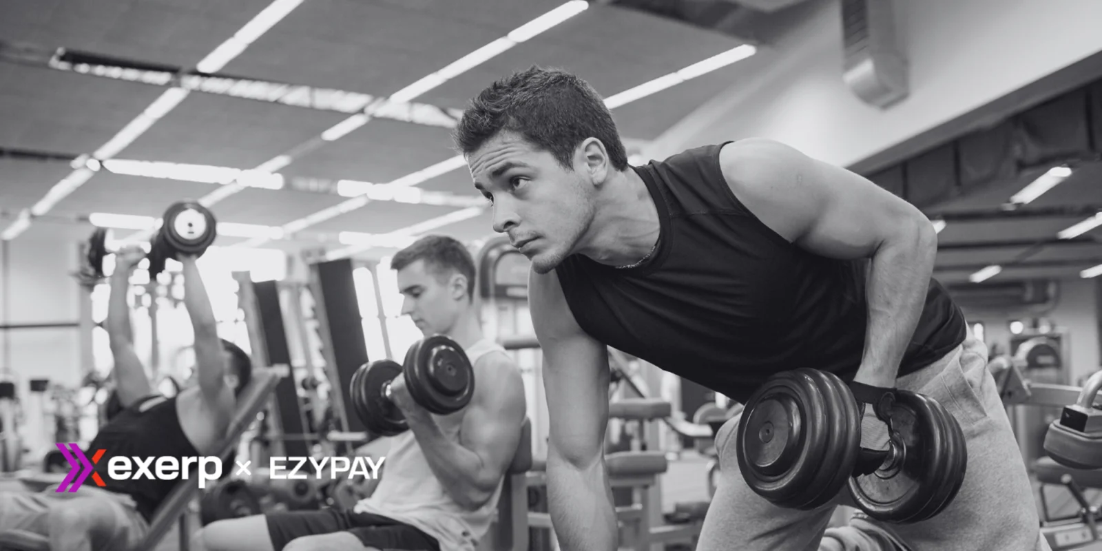 men working out in a gym with dumbbells