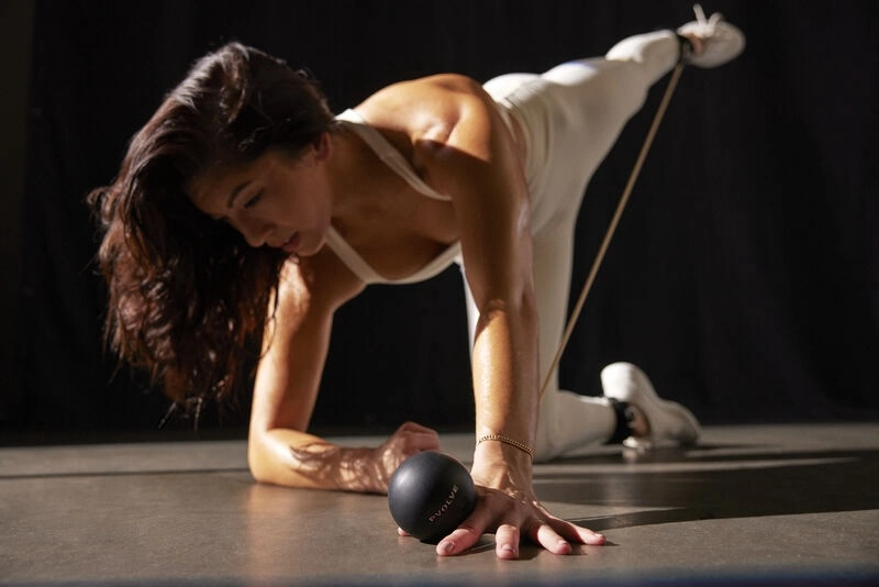 woman works out with Pvolve ball