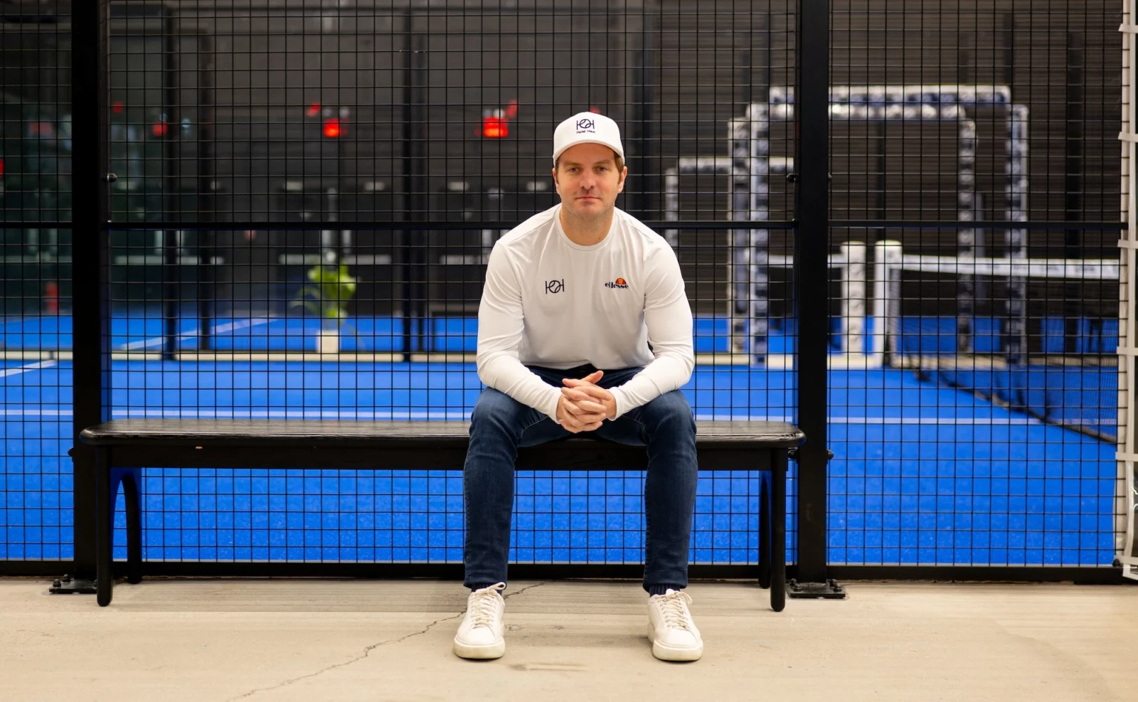 Padel Haus CEO Santiago Gomez poses in front of a padel court