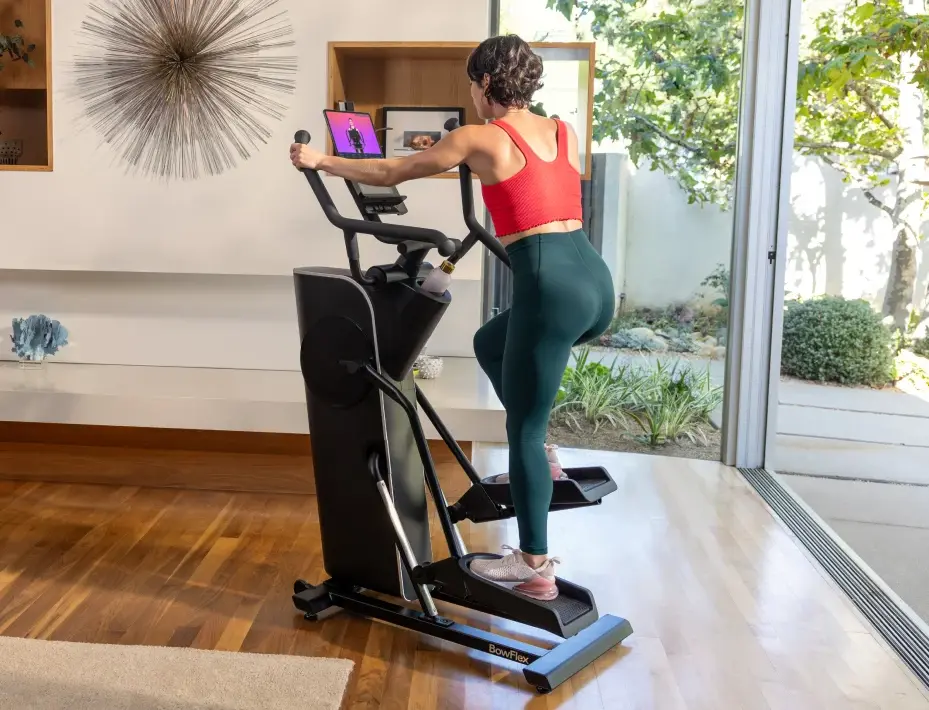 woman works out on a BowFlex elliptical