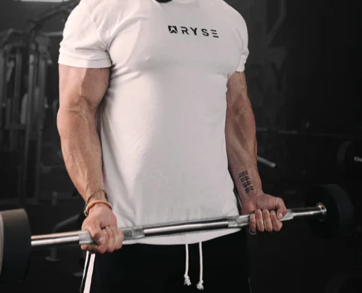 an image of a man wearing a RYSE tee and lifting weights