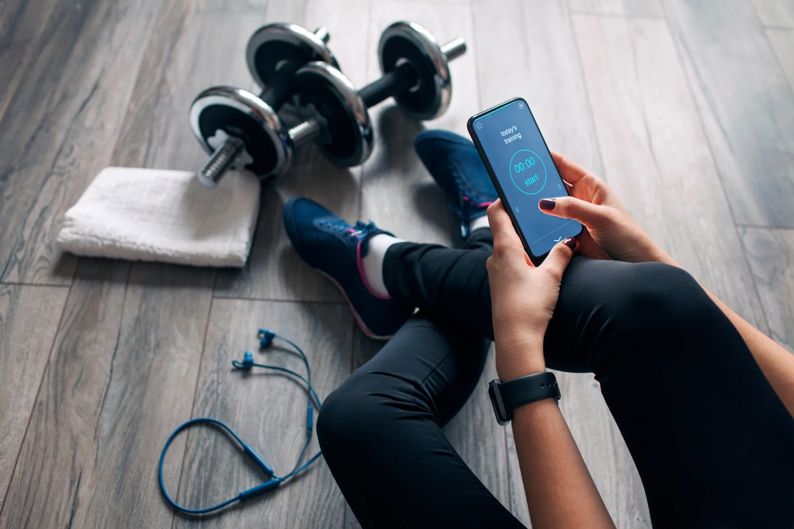 woman looks at a fitness app before working out