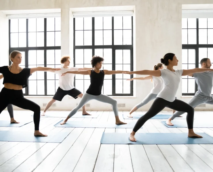 men and woman pose during a yoga class