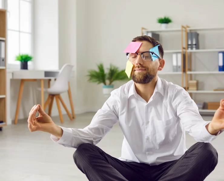 man meditates during a workplace wellness seminar