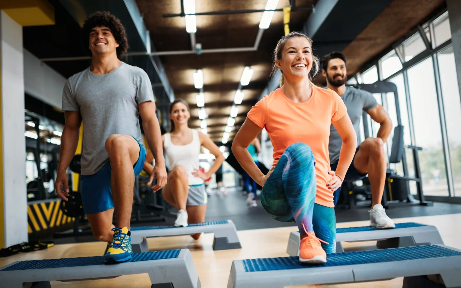 women and men work out in a fitness class