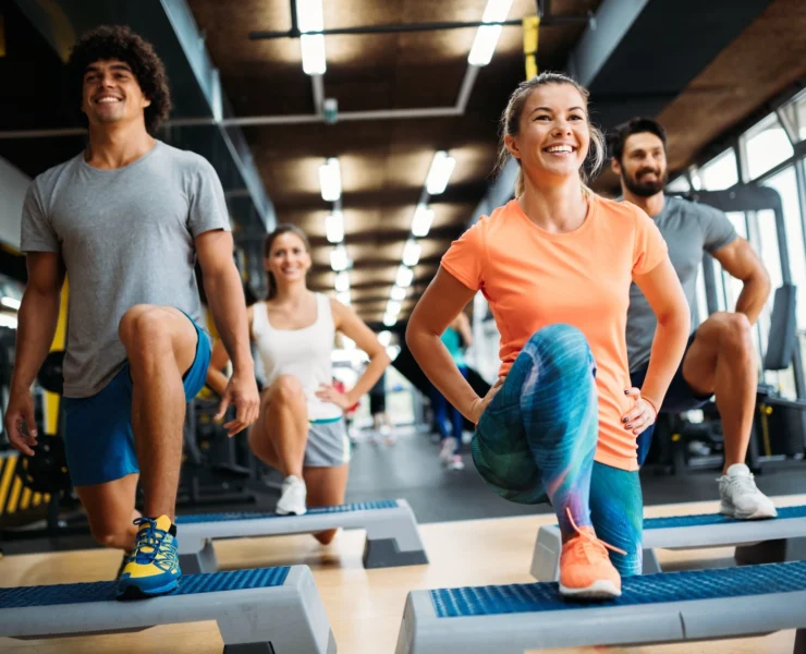 women and men work out in a fitness class