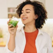 woman drinking greens juice